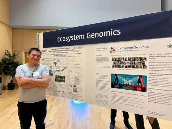 Jhon stands in front of the Ecosystem Genomics poster at the 2023 GIDP Annual Conference 