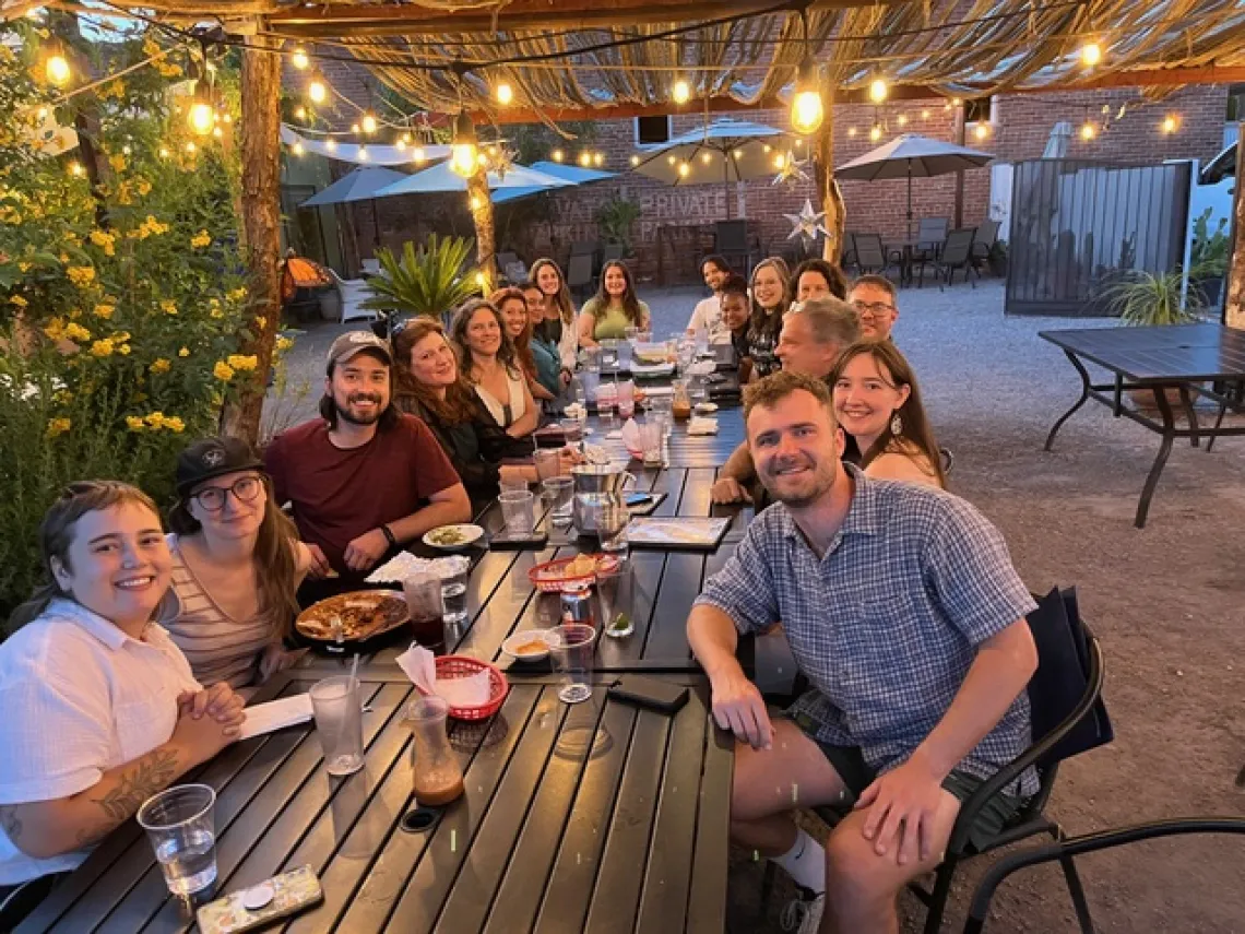 Participants stop for a photo at a dinner with speakers